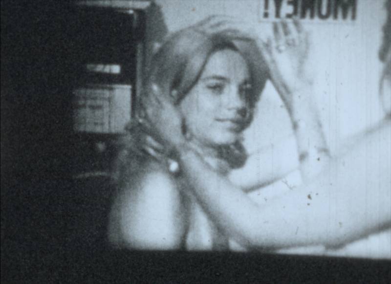 a still from a black and white film of a young woman with light hair