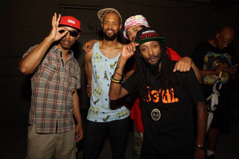 The four MCs of Souls of Mischief - Opio, Tajai, Phesto and A-Plus - pose together at nightlife venue. 