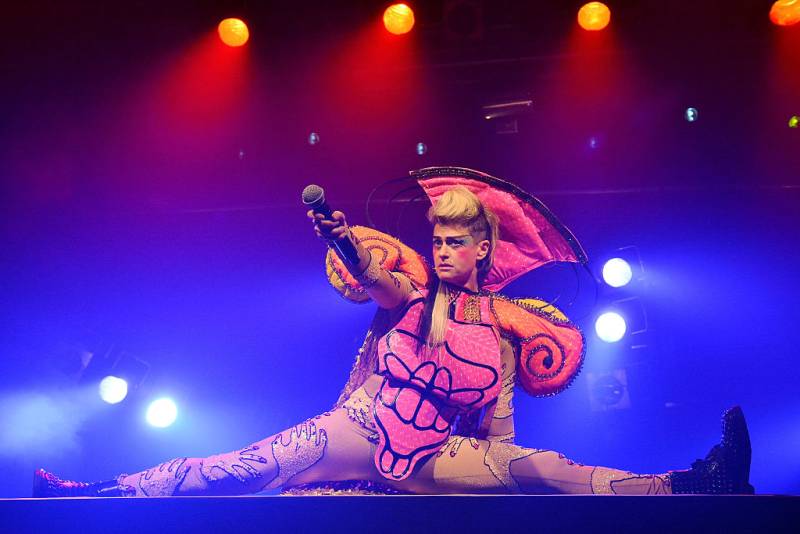 Peaches, wearing faux-hawk, dark eye shadow and a pink, swirly costume, does a full split while holding the microphone out to the audience. 