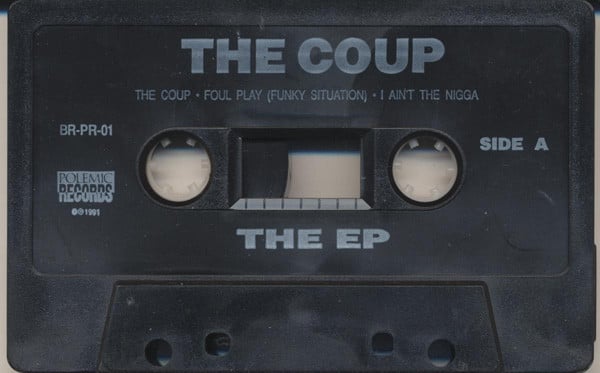 a black cassette tape that reads 'The Coup, The EP' in white letters