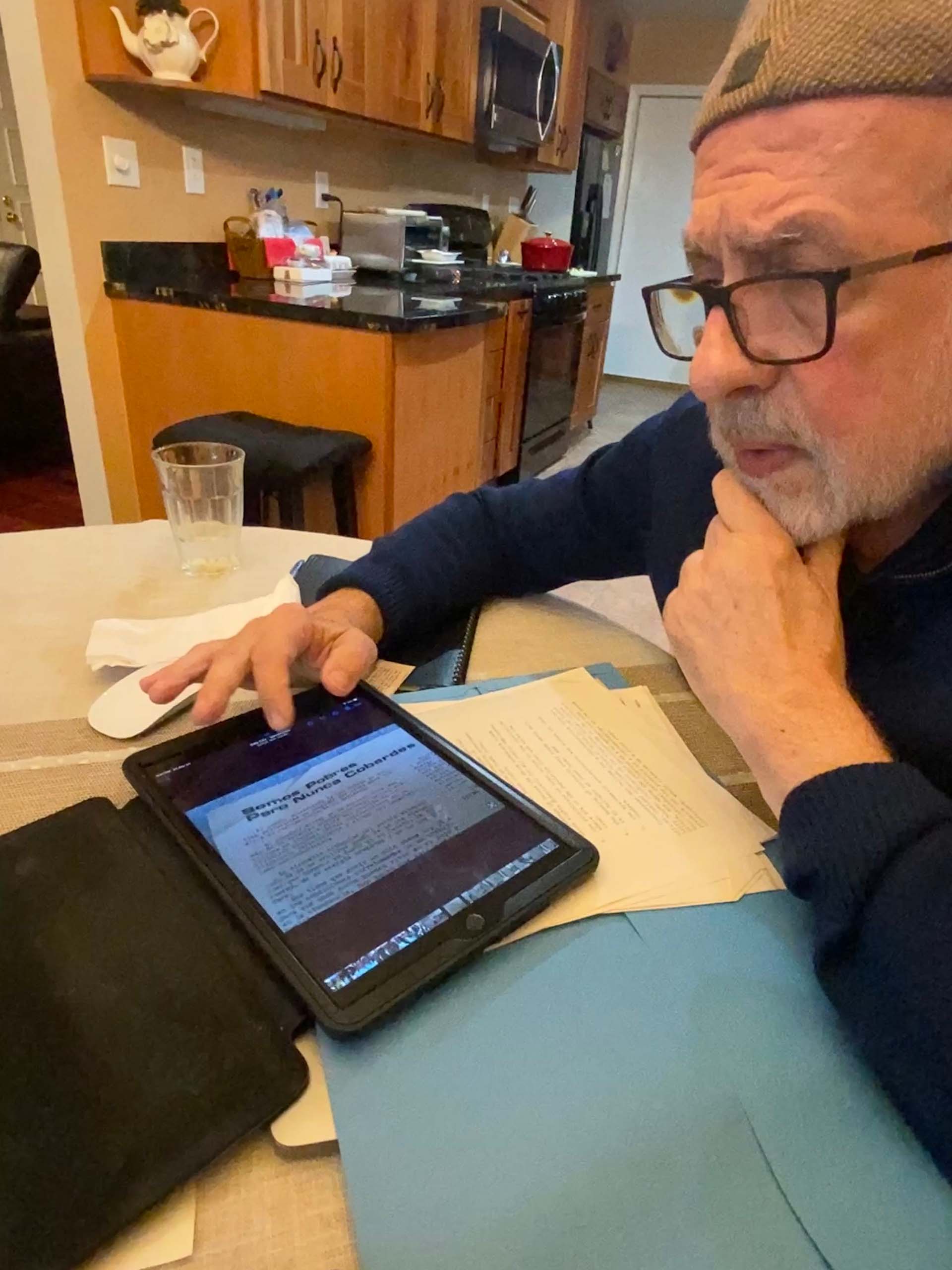 Man in glasses shows an article that he's loaded onto his iPad.