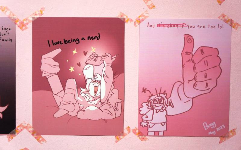 pink artwork on a wall that reads 'I love being a nerd'