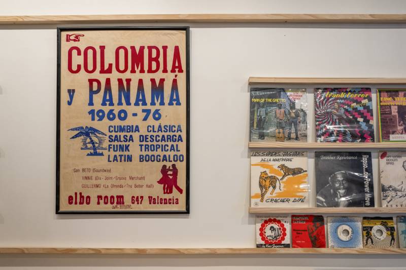 a poster from a concert in panama hangs on the wall of a record store