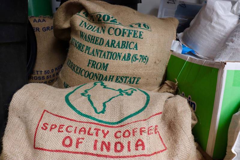 two bags of "specialty coffee of India" sit inside a coffee roasting warehouse in Berkeley