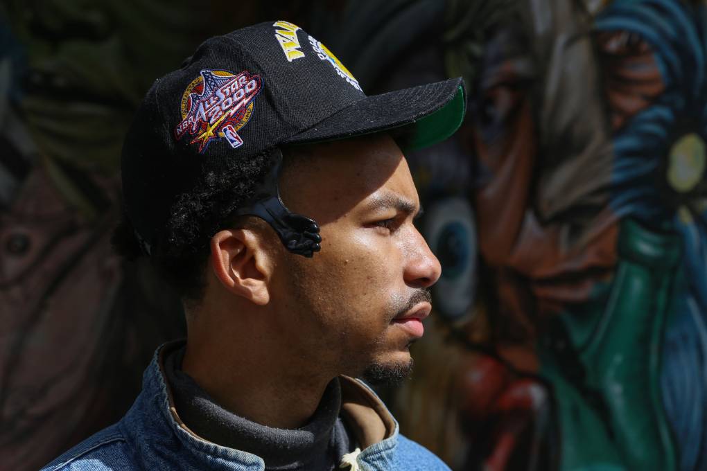 The facial profile of a young Oakland rapper as he looks away from the camera