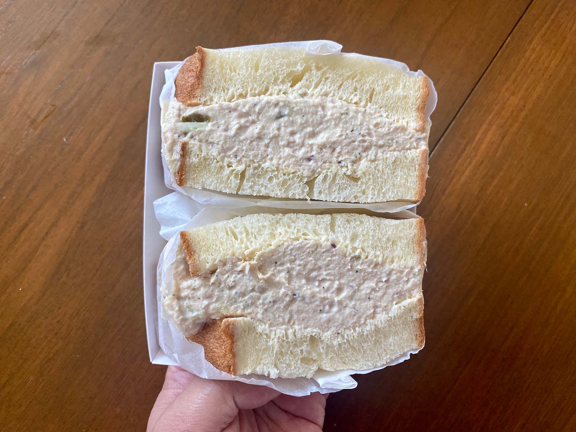 The cross section of a tuna salad sandwich made with thick slices of milkbread.
