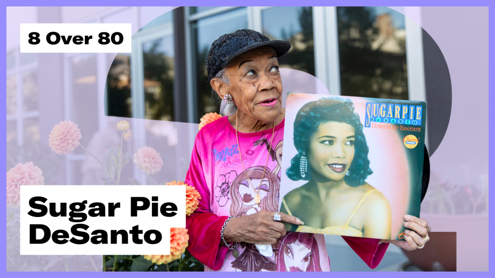 An 87-year-old woman with a pink top and sequined hat poses in front of flowers with text "8 Over 80" and "Sugar Pie DeSanto" overlaid