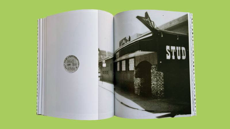 Open book with image of round pin on left page, black and white photo of exterior of bar on right, light green background