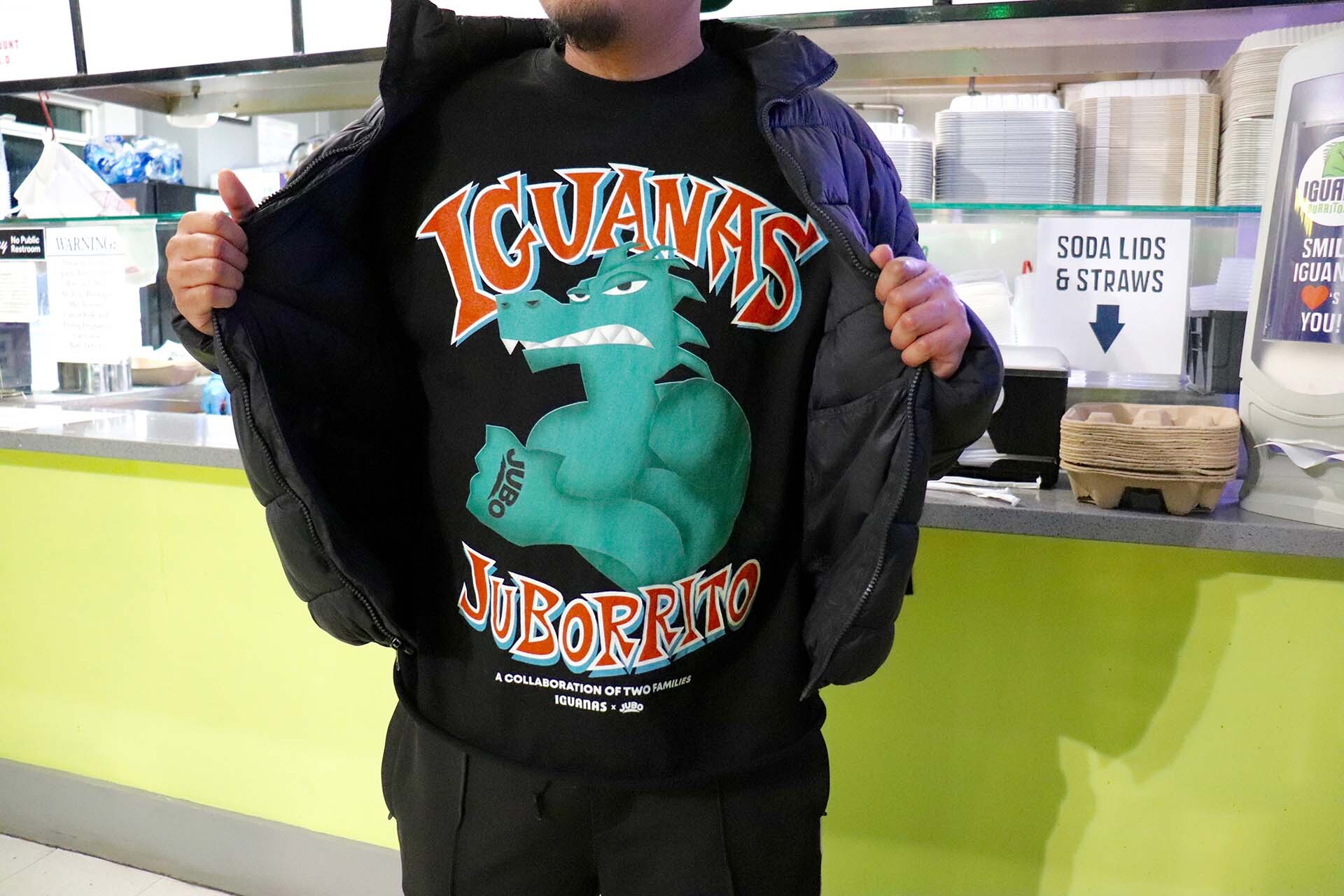 a San Jose artist showcases a shirt he designed for a local taqueria
