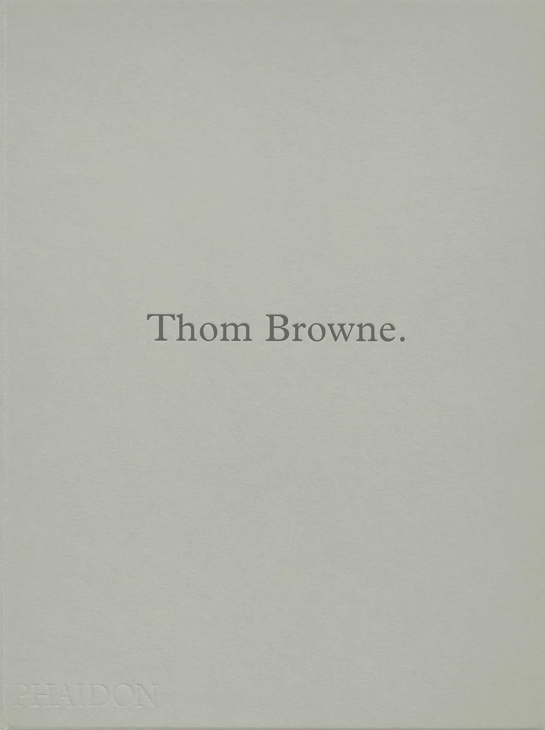 A plain grey book cover with the words Thom Browne on it.