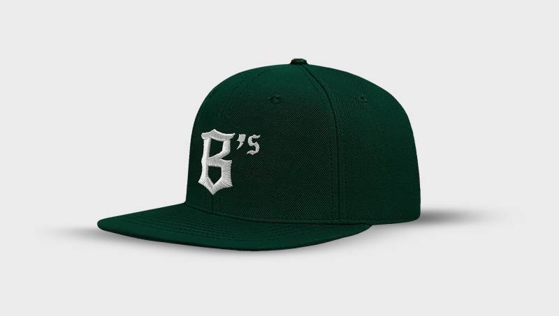 a green baseball cap with an emblazoned B in old English lettering