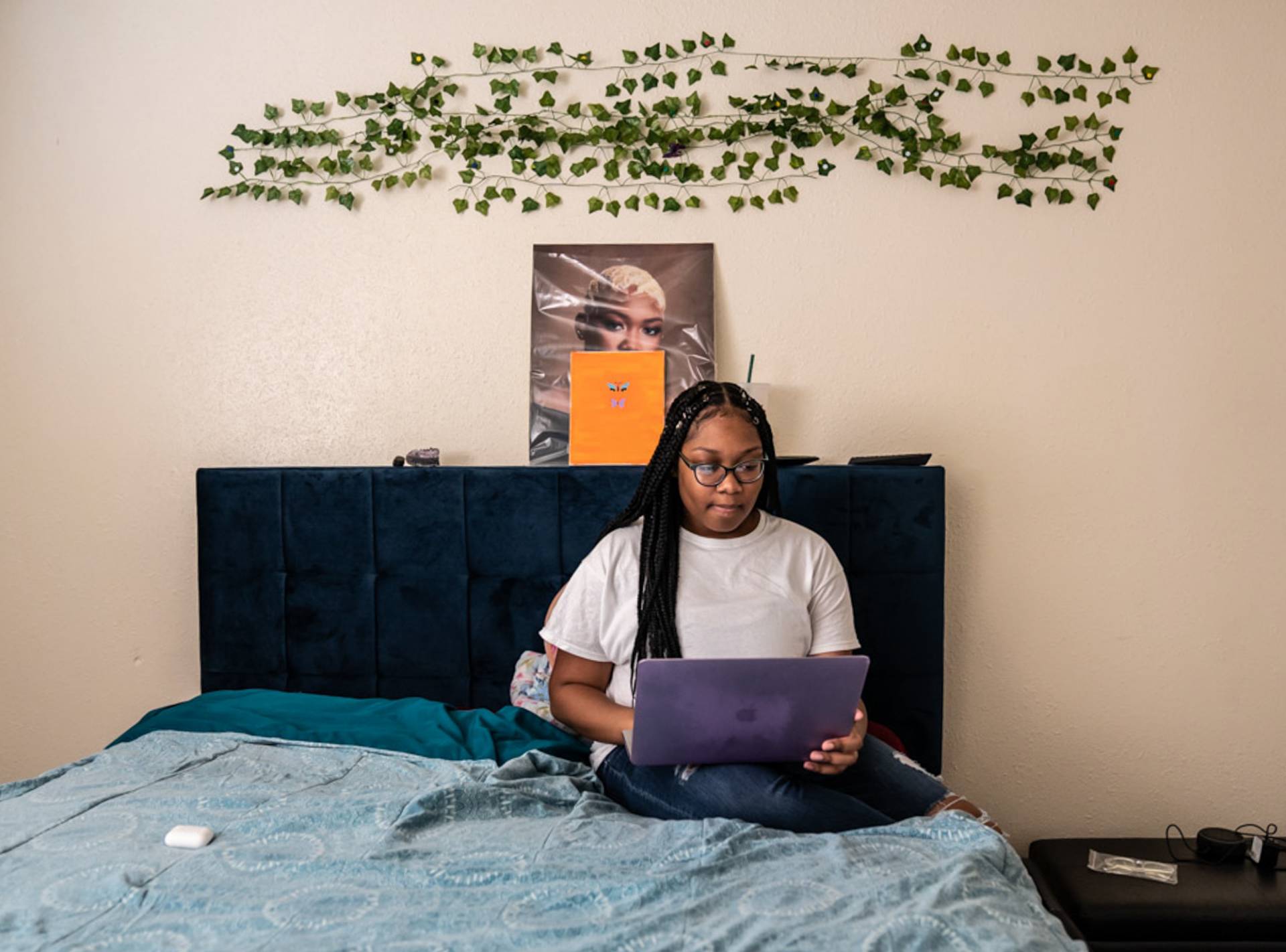 Jonetta Harrison, sits on her computer in her bedroom where she recorded her part for the podcast "Loss And Transformation."