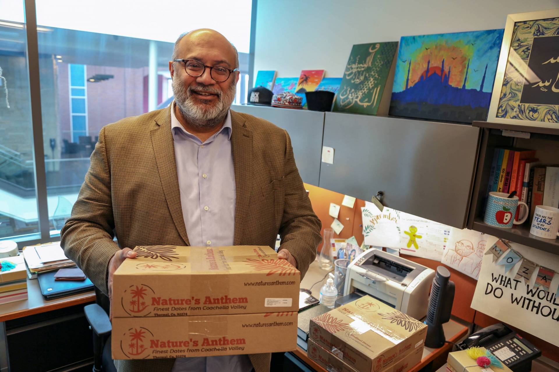University Muslim chaplain holds a box of dates