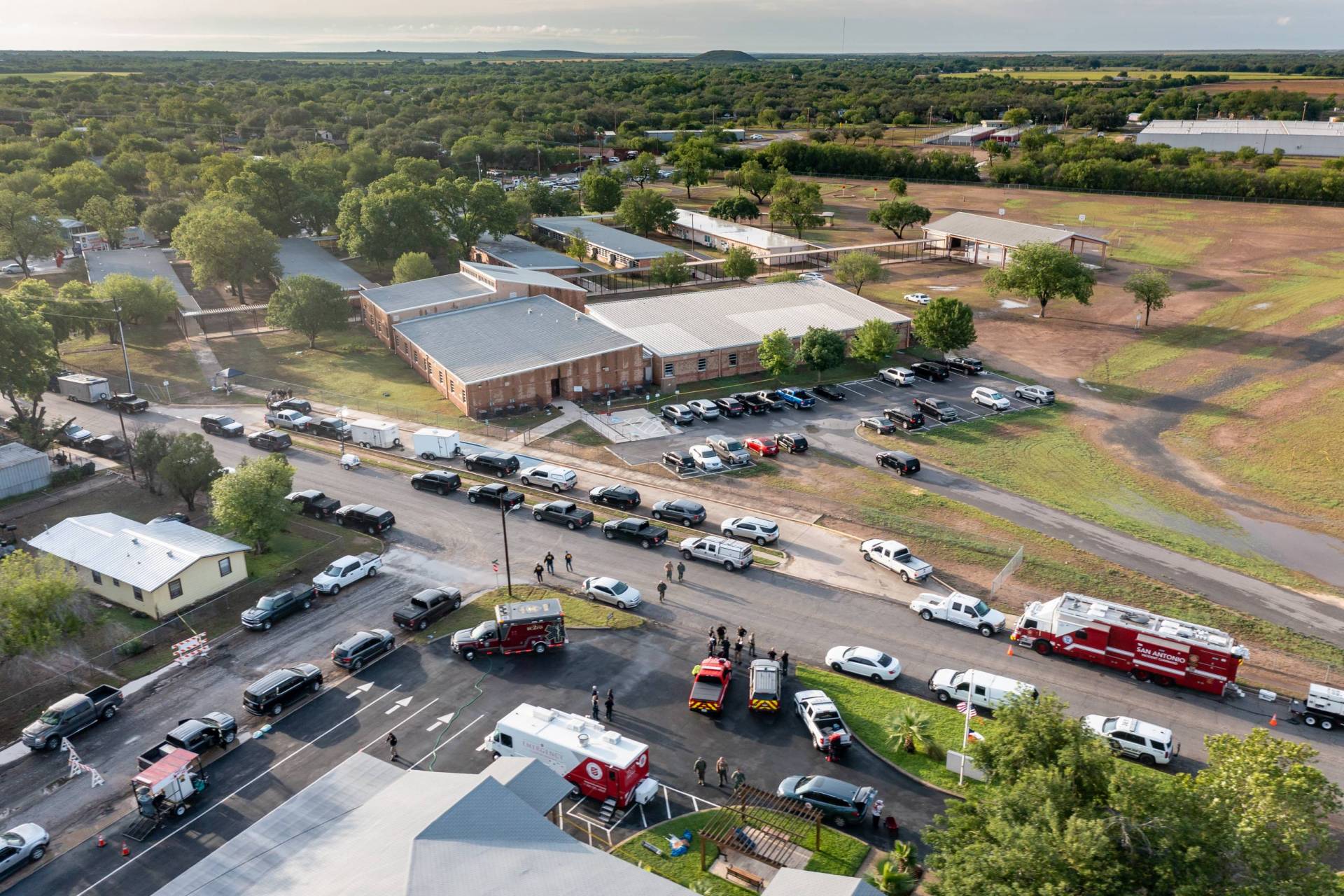 In this aerial view, law enforcement works on scene after at shooting Robb Elementary School in Uvalde, Texas.