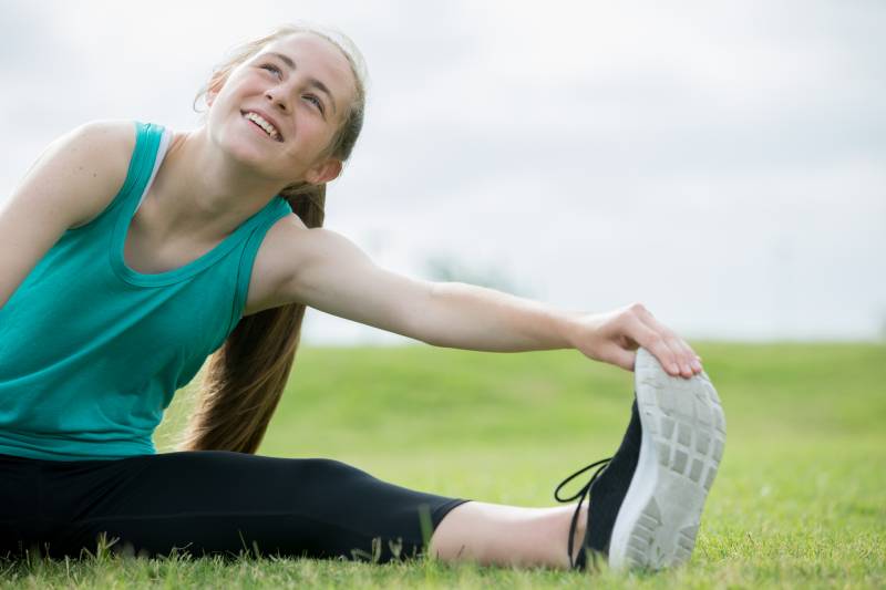 Girl stretching on a field