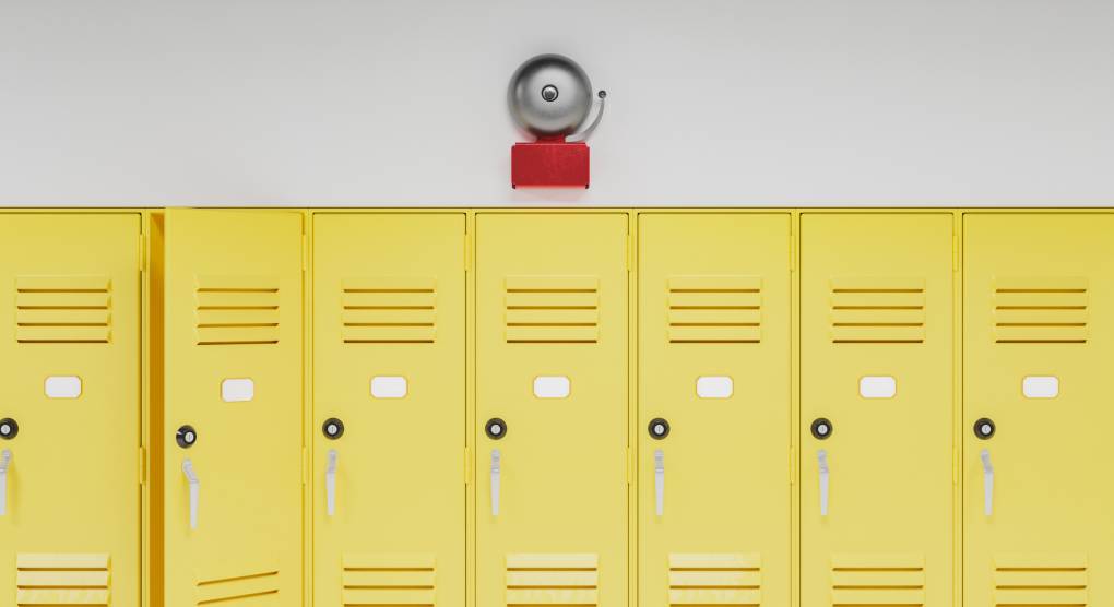 school bell above a row of yellow lockers.