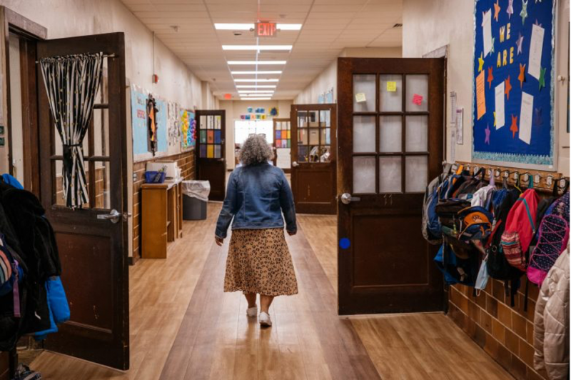 Teacher walking through hallway of a school