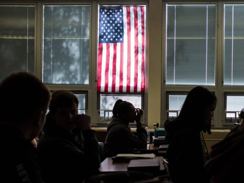 Students in class with U.S. flag in window