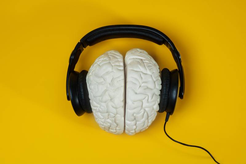 Headphones on the brain over the yellow background