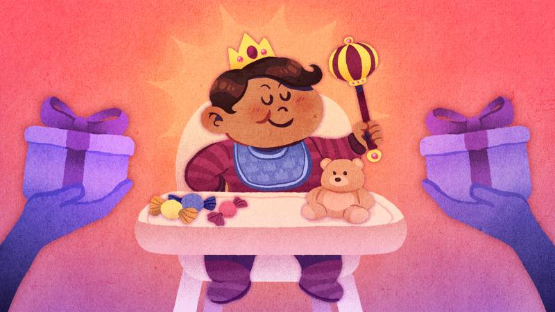A child in a high chair wears a jeweled crown and holds up a scepter. On the high chair's table is a stuffed animal and a small pile of candies. On each side, the parents' hands hold up gifts to their child.