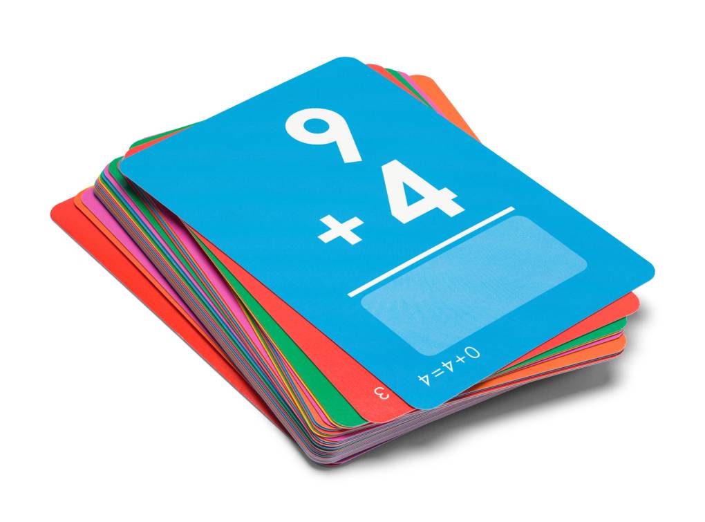 a blue flash card with white numbers 9 + 4 on top of a stack of colorful flash cards