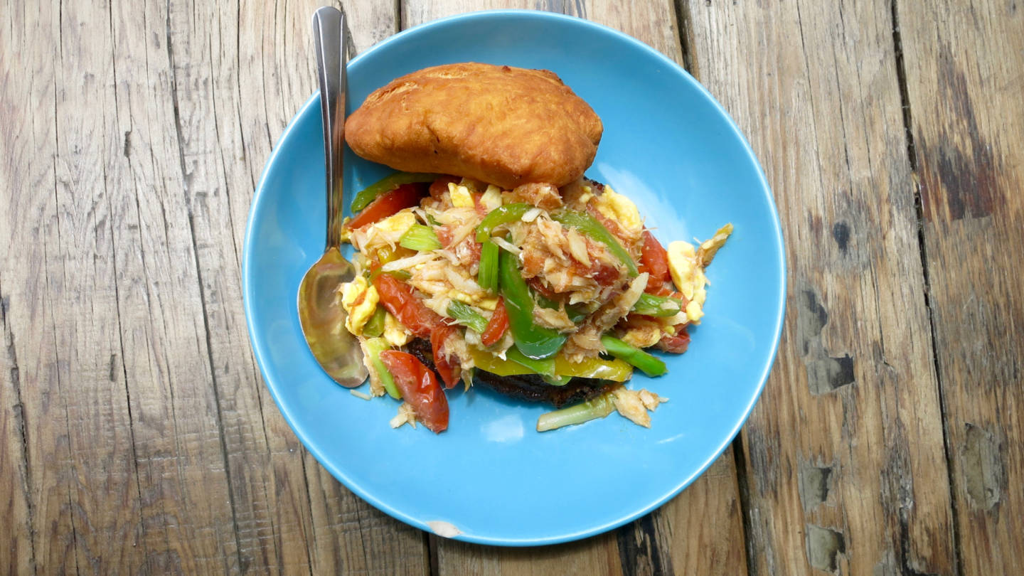 Miss Oliie's spicy salt fish and ackee comes with sweet plantains and a large "bake", or fried dough, that you can use to soak up the juices from your meal. Jenny Oh