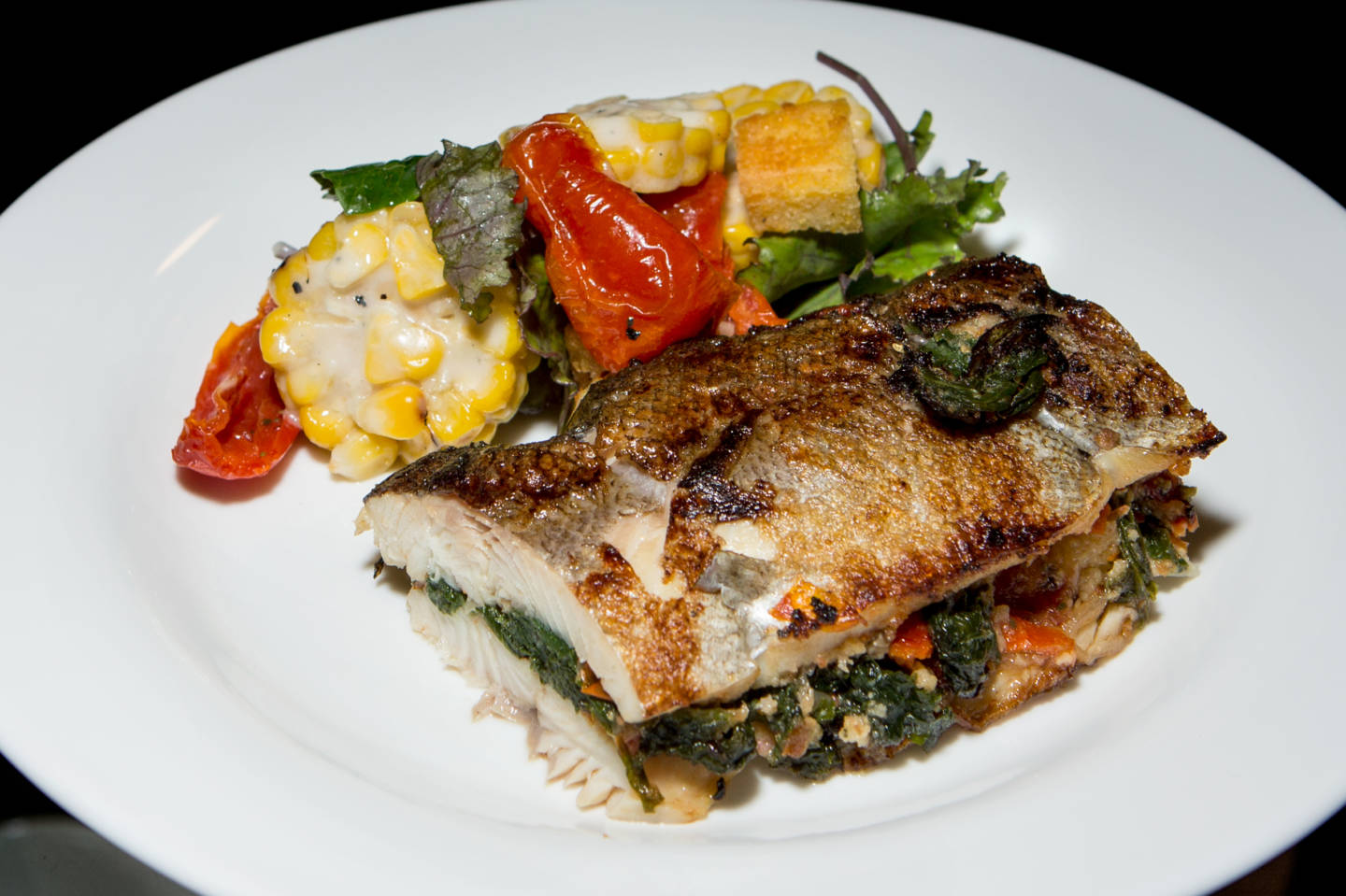 Pan Roast Rainbow Trout, served with cornbread and mustard greens stuffing and hazelnut brown butter, a seafood offering in the Western Range.  Ariel Zambelich/NPR