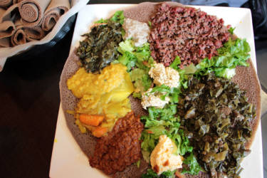 A combo platter with vegetable dishes and kitfo at Tadu Ethiopian Kitchen in SF.