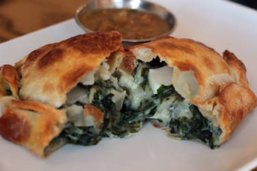 El Sur's vegetarian verde empanada with Swiss chard, spinach, onion, cheese sauce, olive and egg