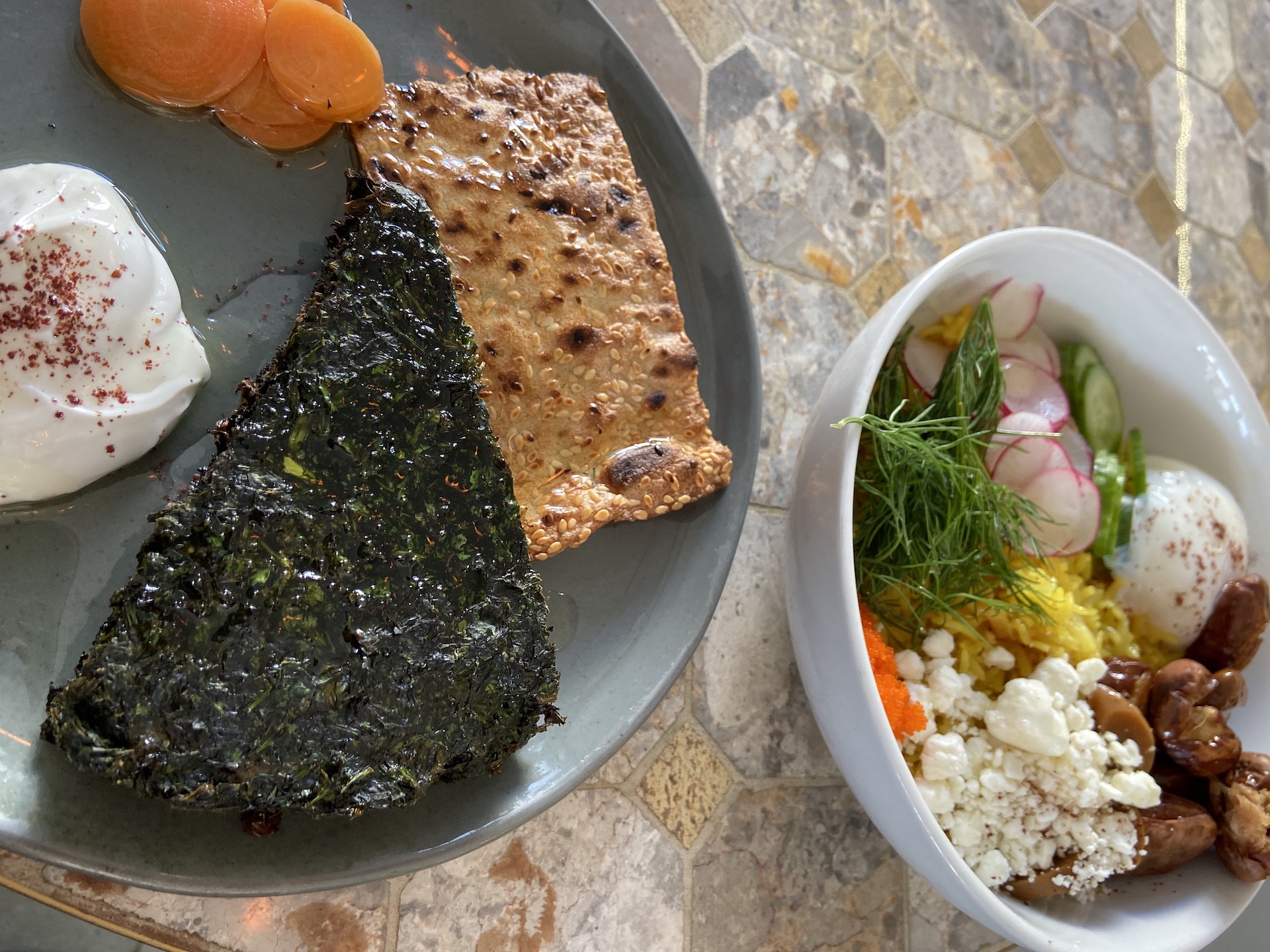 Kuku Sabzi, an herb frittata, served with sumac labneh, pickled carrots and toasted flatbread.
