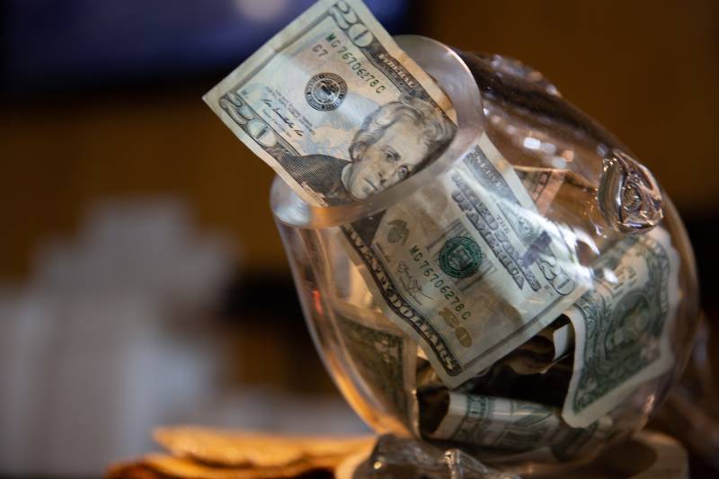 Twenty dollar bill in a tip jar