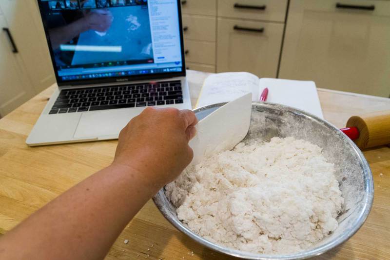 Rice and tapioca flours are mixed with boiling water to make khao piak sen noodles during an online cooking class with 18 Reasons