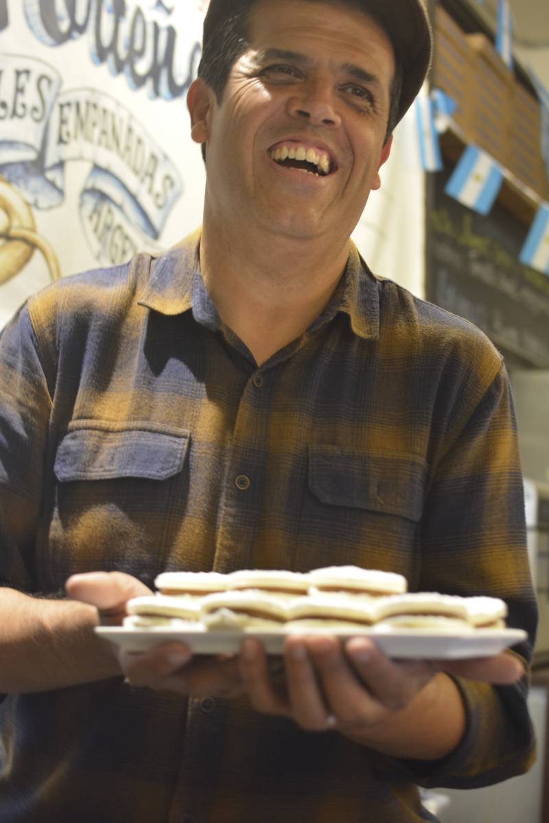 Chef Joseph Ahearne holding a tray of alfajores