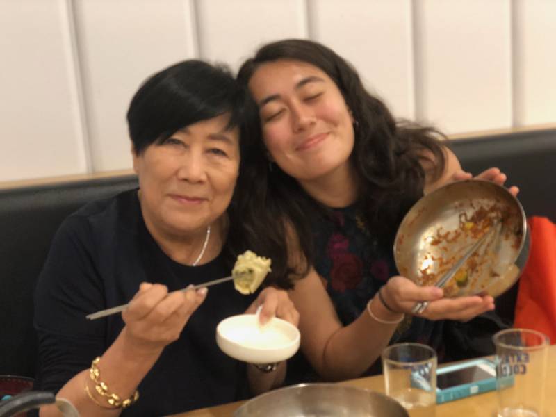 Granddaughter and grandmother eating