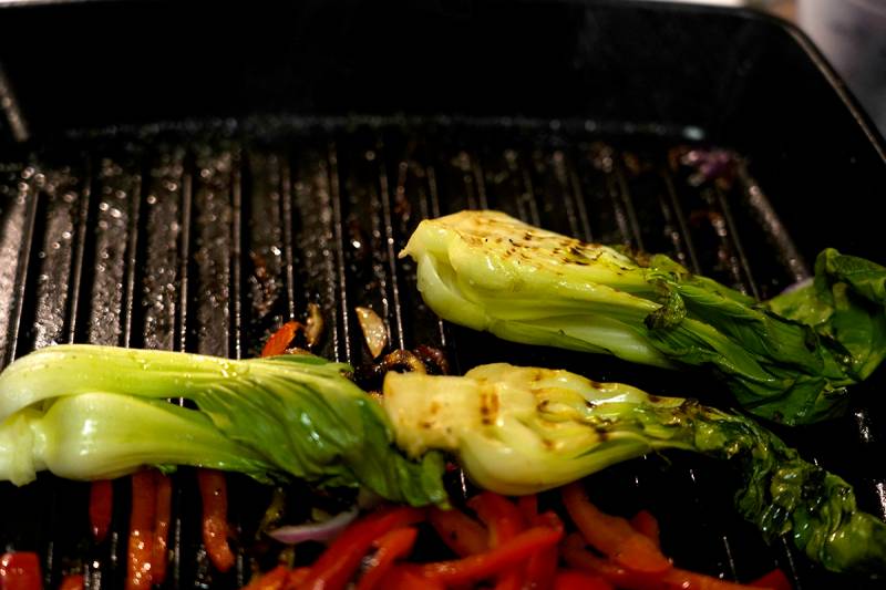 Charred baby bok choy on a grill pan