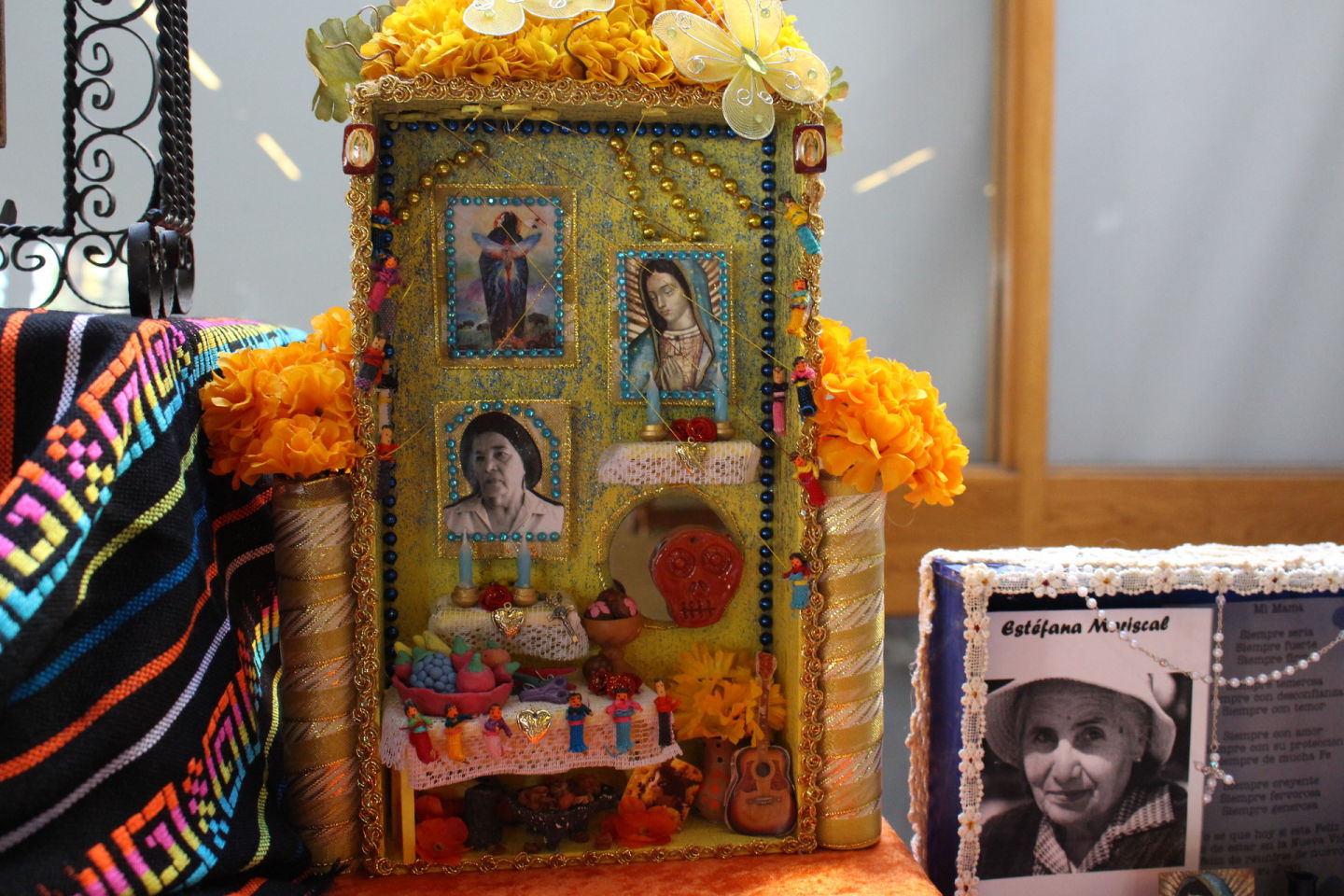 Nichos decorate an altar at the Oakland Museum of California for Day of the Dead. The central inch was made by art therapist Alicia Diaz to honor her grandmother. Diaz says was very religious and loved the color yellow. Farida Jhabvala Romero /KQED