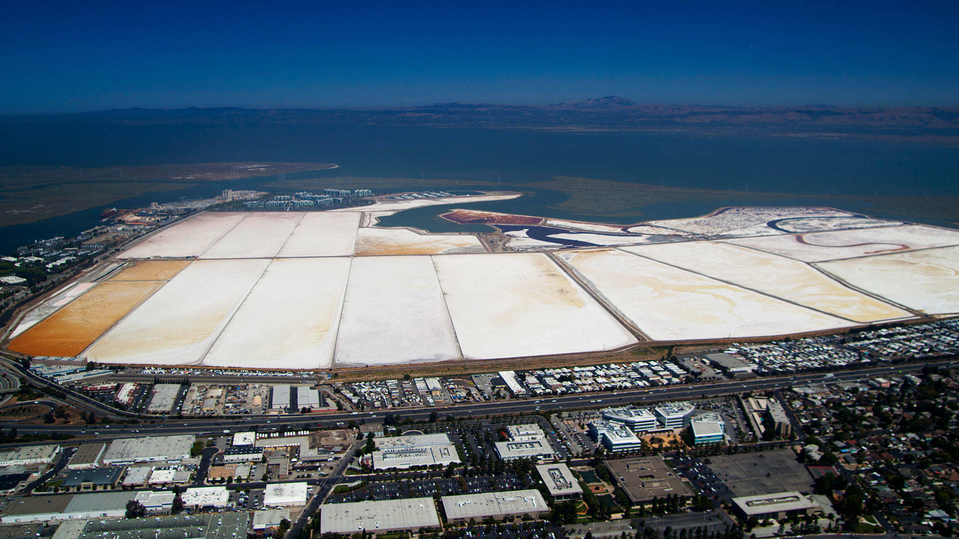 An aerial image of Cargill's property, with Highway 101 and Redwood City in the foreground. Image courtesy Redwood City Saltworks.
