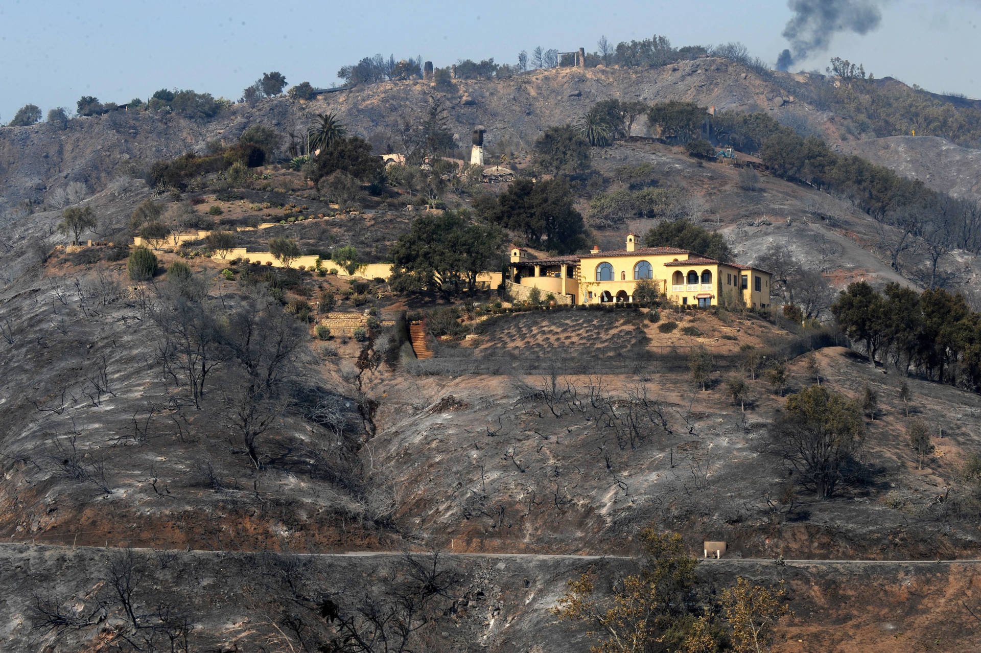 A mansion saved from a raging wildfire sits on a scorched hillside in Santa Barbara, November 2008.  Robyn Beck/AFP/Getty Images