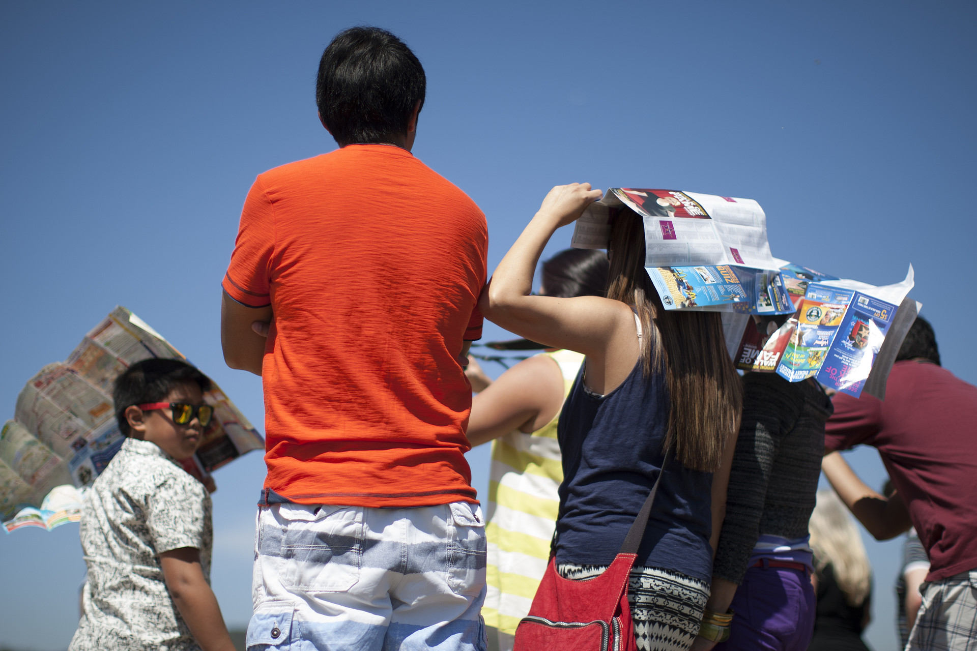 People hold Hollywood tourist maps over their heads as makeshift sunshade in Griffith Park in March 2015 in Los Angeles, California. A record-breaking series of unusual heat waves made this the first March to have had six days with highs in the 90s or above in Los Angeles since at least 1877 when record-keeping began.