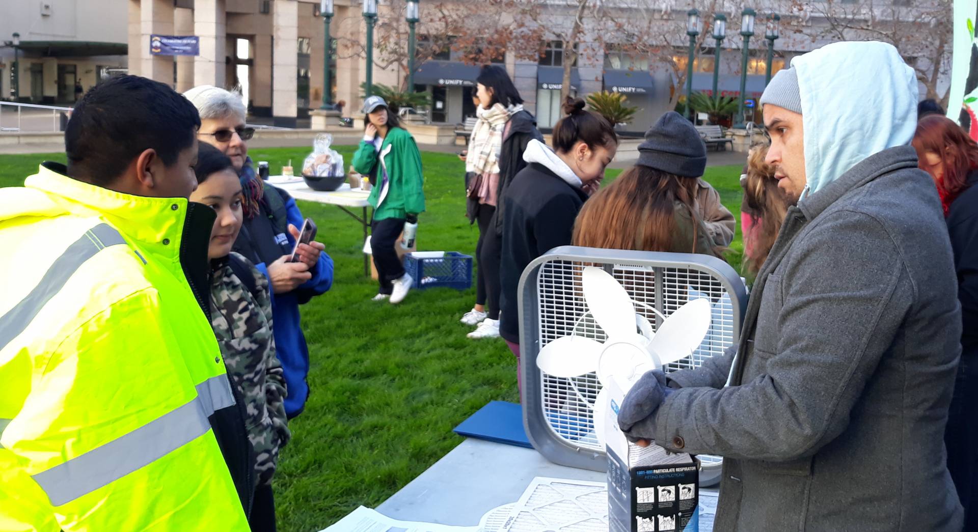 Dani Cornejo, an educator with the Mycelium Youth Network, teaches young people how to make their own air purifiers out of a box fan and air filter at a climate change event in Oakland in January. Lil Milagro Henriquez/Mycelium Youth Network