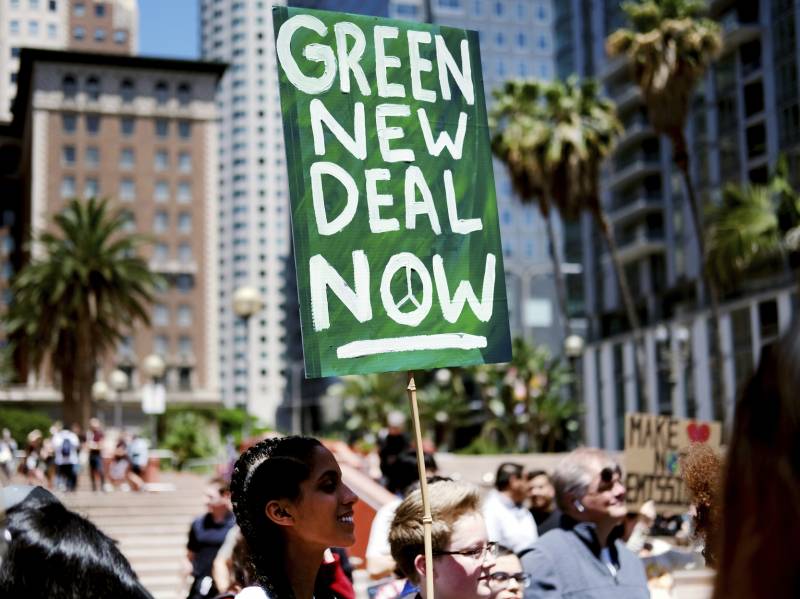 Climate change activists holding signs join in on a rally supporting the "Green New Deal" in Pershing Square in downtown Los Angeles on Friday, May 24, 2019.