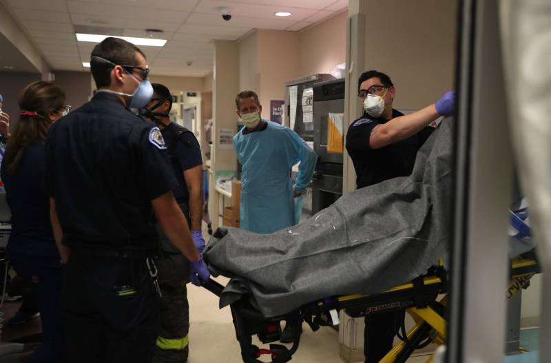 Paramedics drop off a patient in the emergency room at Regional Medical Center on May 21, 2020 in San Jose. Frontline workers are continuing to care for COVID-19 patients throughout the San Francisco Bay Area. Paramedics and hospital workers are among those covered under the state's Airborne Transmissible Disease rule.