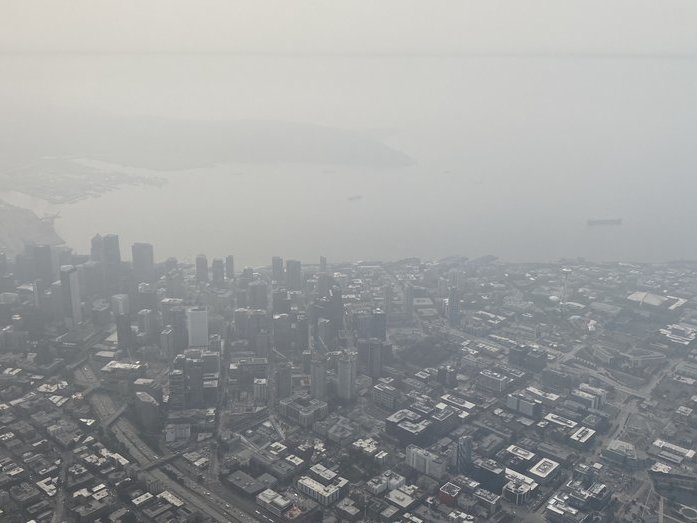 a panoramic view of downtown Seattle with a smoky sky