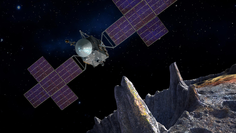 A spacecraft with purple wings flies above the ragged peaks of a gray asteroid.
