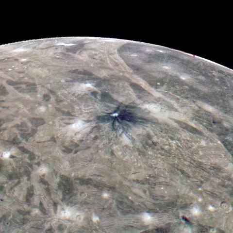 Jupiter's moon, Ganymede, etches a curve of white against a black sky. The planet's surface is a crisscrossing network of dun-colored streaks, punctuated by white sparks. 