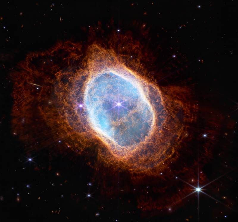 The bright star at the center of NGC 3132, Southern Nebula Ring, while prominent when viewed by NASA's Webb Telescope in near-infrared light, plays a supporting role in sculpting the surrounding nebula. A second star, barely visible at lower left along one of the bright star's diffraction spikes, is the nebula's source. It has ejected at least eight layers of gas and dust over thousands of years.