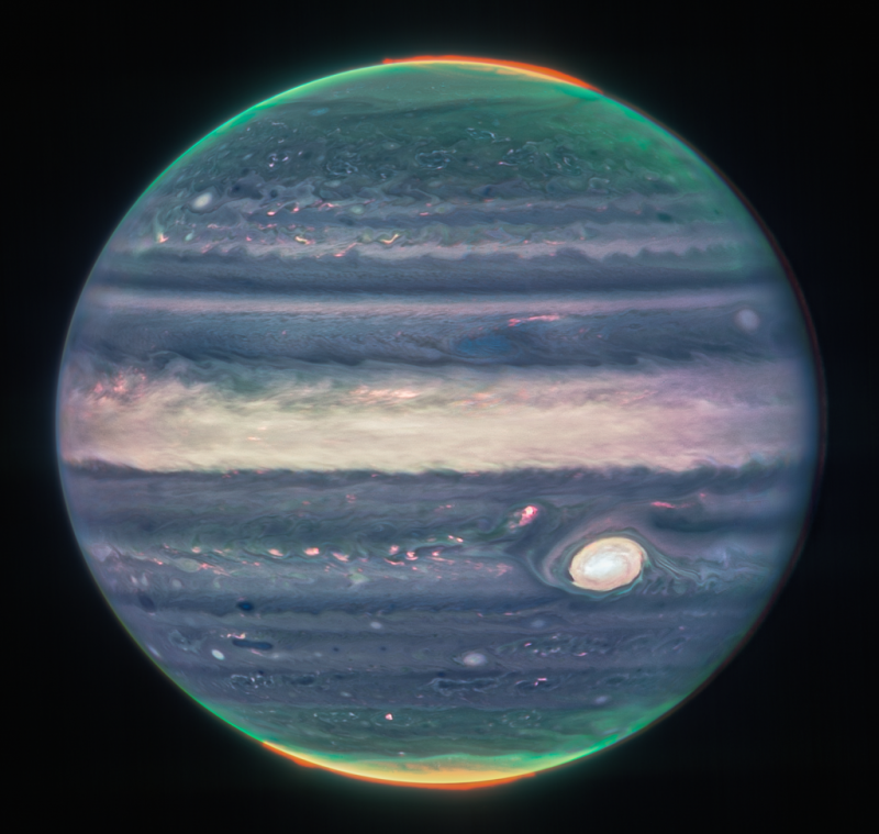 Webb NIRCam composite image of Jupiter from three filters – F360M (red), F212N (yellow-green), and F150W2 (cyan) – and alignment due to the planet’s rotation.