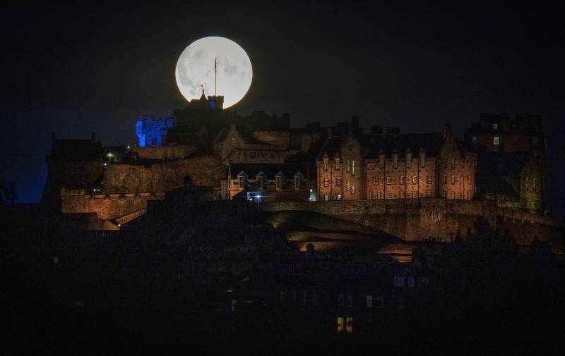 The Sturgeon supermoon, the final supermoon of the year, rises behind Edinburgh Castle. Picture date: Thursday August 11, 2022. (Photo by Jane Barlow/PA Images via Getty Images)