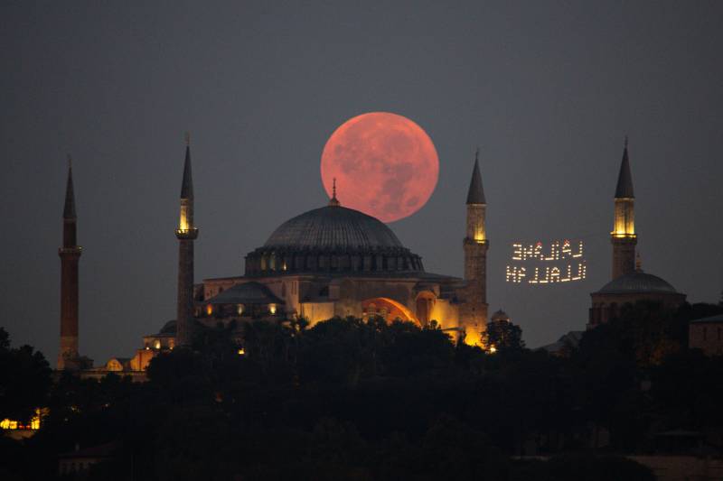 The Super Moon sinks behind the Hagia Sophia Mosque on August 11, 2022 in Istanbul, Turkey. (Photo by Hakan Akgun/dia images via Getty Images)