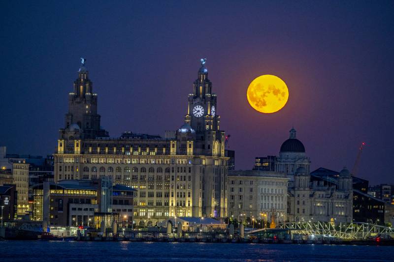The Sturgeon supermoon, the final supermoon of the year, rises over the Royal Liver Building in Liverpool. Picture date: Thursday August 11, 2022. (Photo by Peter Byrne/PA Images via Getty Images)